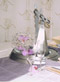 Little Ironies figurine with orchid arrangement from Waow Studio